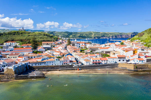 Idyllic beach Praia and azure bay Baia do Porto Pim. Fortifications, walls, gates, red roofs of historical touristic Horta town centre, yachts in the port, Faial island, Azores, Portugal, Europe stock photo