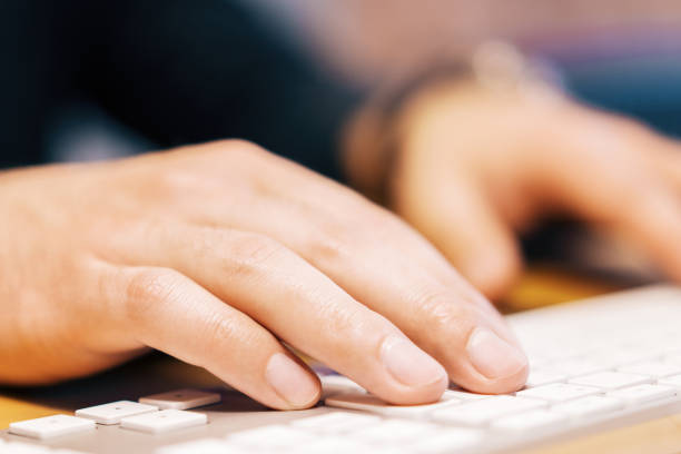 istock Closeup of businessman hands using keyboard 1164779483