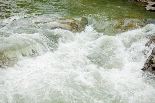 istock Stones and mountain river with small waterfall, blurred background, the flow of a mountain river 1164780691