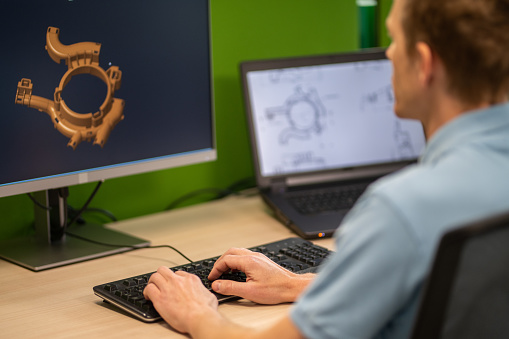 3d Computer Engineer Engineer Using A Computer To Make A 3d Model Of A Machine Part Stock ...