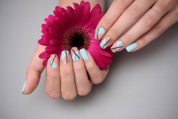 istock Beautiful delicate manicure on female hands, on pastel background. 1164781537