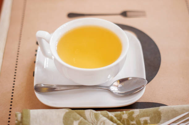 istock A white Cup of herbal tea on a saucer on a table in a cafe. 1164781762
