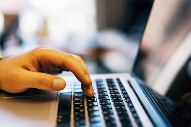 istock Sideview of male using laptop on desk top 1164781764
