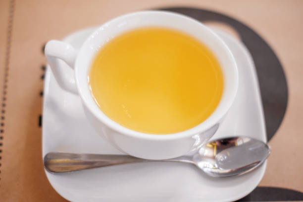 istock A white Cup of herbal tea on a saucer on a table in a cafe. 1164781769