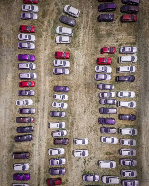 Photo of Birds Eye view of white, red and purple cars