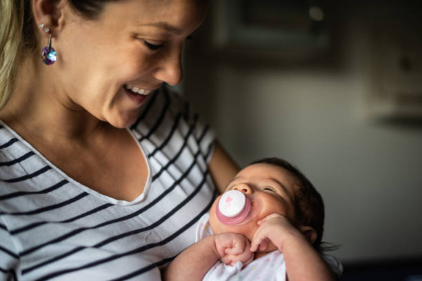 istock Mother holding newborn baby 1164785253