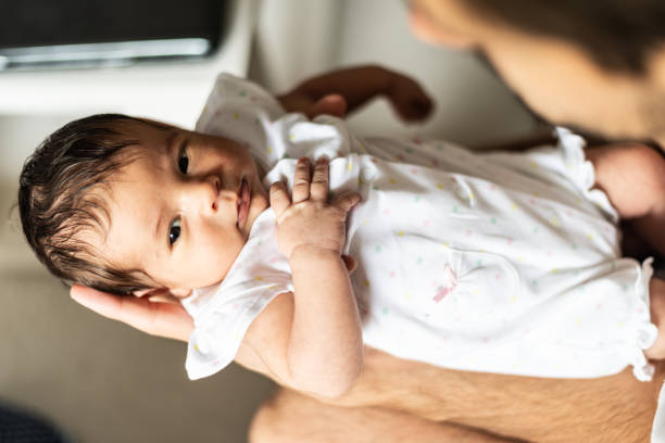 istock Father holding newborn baby 1164785283