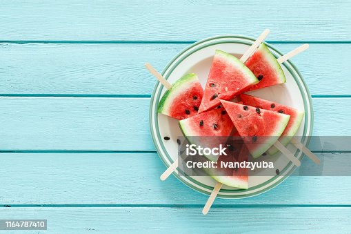istock Watermelon slice popsicles, blank food bacground with space for a text, top view 1164787410