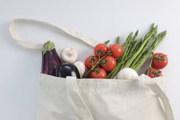 istock Zero waste use less plastic concept / Fresh vegetables organic in eco cotton fabric bags on white background. Fresh eggplants, asparagus, mushrooms, tomatoes 1164787440