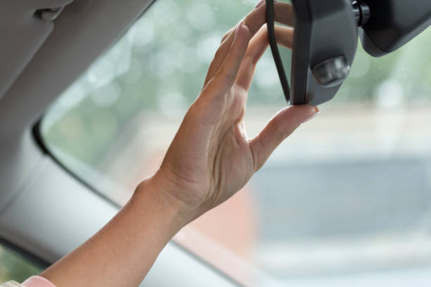 istock the girl in the car mirror adjusts 1164790700