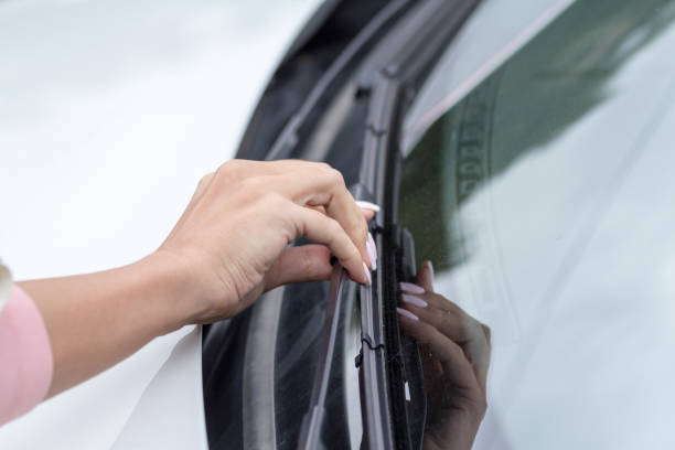 istock Girls hand checks wipers car 1164792597