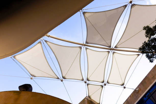 istock Low angle view of modern white sunshades, background with copy space 1164792769