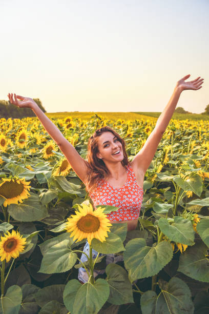 istock Happy woman in sunflower field 1164793785