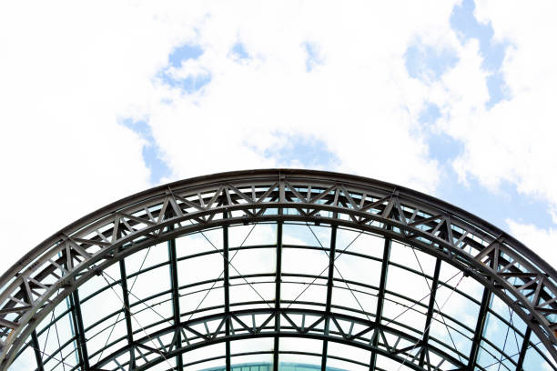 Modern steel roof arch structure, sky background with copy space, full frame horizontal composition