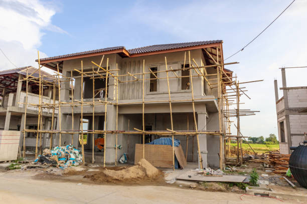 istock construction residential new house in progress at building site with clouds and blue sky 1164801505