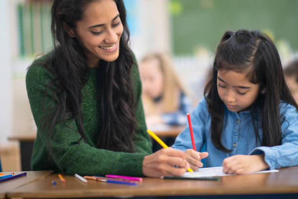 istock Beautiful teacher helps her Indian student 1164801531