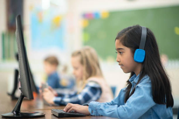 istock Indian girl typing on her computer in class 1164801554