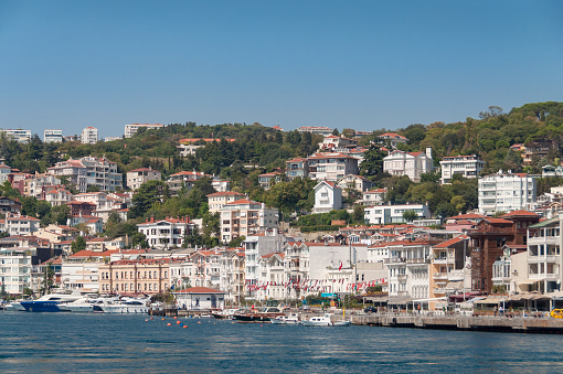 Waterfront houses and Arnavutkoy iskalesi ferry stop. Residential property in Istanbul Arnavutkoy suburb
