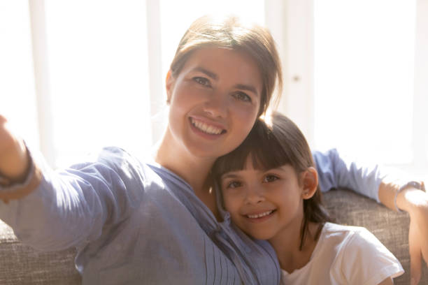 istock Smiling mom and little daughter make selfie together 1164802831