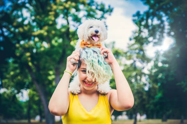 istock Happy young woman and her pappy dog. 1164802907