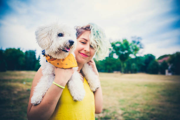 istock Young woman carrying her dog 1164802969