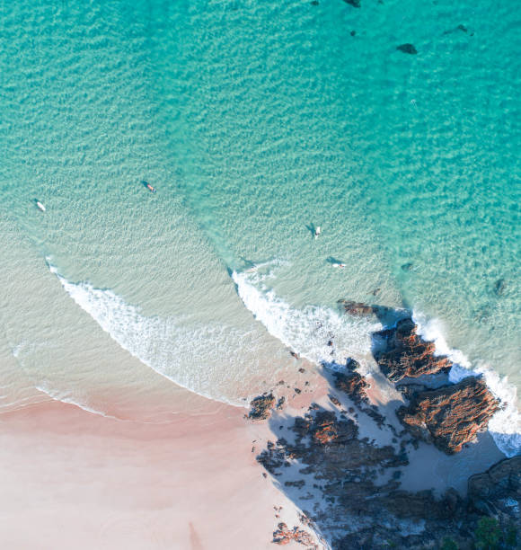 istock Waves from above at sunrise with surfer enjoying holiday time and surf session 1164806613