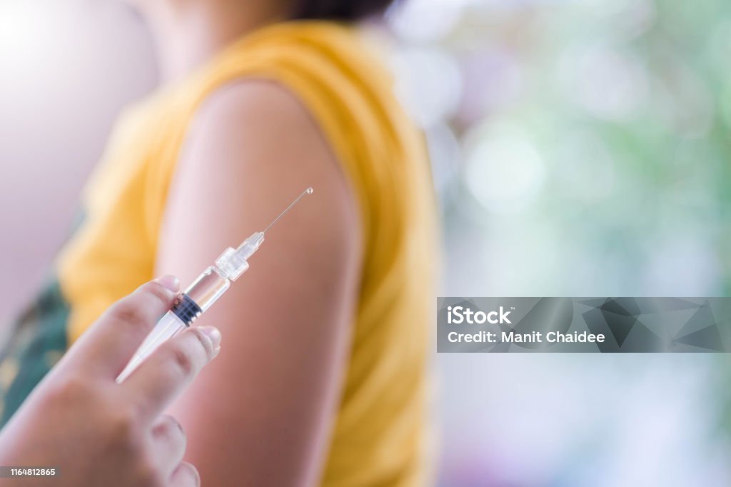 Closeup of doctor hand are vaccinations to patients using the syringe.Medical concept Vaccination Stock Photo
