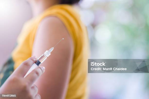 Closeup Of Doctor Hand Are Vaccinations To Patients Using The Syringemedical Concept Stock Photo - Download Image Now