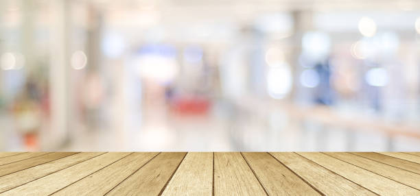 istock Wooden table, tabletop, desk over blur store with bokeh light background, Empty wooden shelf, counter, desk for retail shop product display background, Wood table top surface for food backdrop, mockup 1164817211