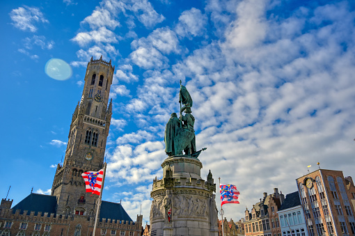 The Jan Breydel and Pieter de Coninck statue located in the historical city center and Market Square (Markt) in Bruges (Brugge), Belgium on a sunny day.