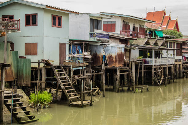 Traditional thai communities and trade boat at pier.