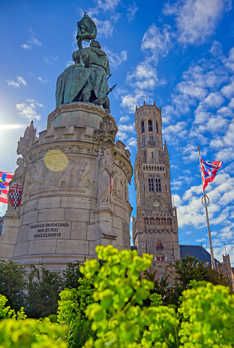 The Jan Breydel and Pieter de Coninck statue located in the historical city center and Market Square (Markt) in Bruges (Brugge), Belgium on a sunny day.
