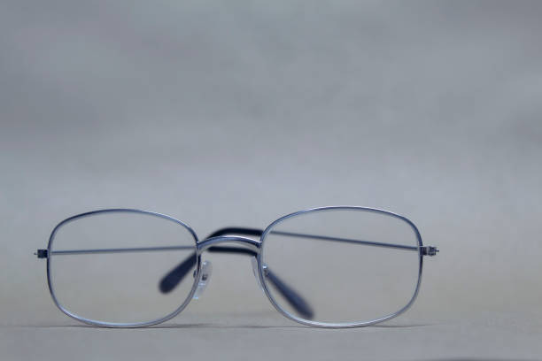 istock Glasses for sight with clear glass lie on a neutral background. 1164822201