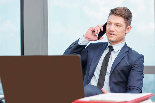 istock Businessman answering phone 1164823128