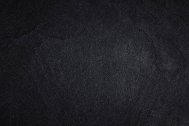 istock Dark grey black stone for background or natural black slate texture 1164825283