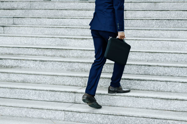 istock Businessman walking up the stairs 1164826127