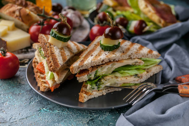 istock Close-up toasts with scrambled eggs, vegetables and cheese. Tomatoes and spices. Delicious breakfast or snack 1164828699