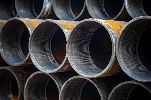 istock high quality Galvanized steel pipe or Aluminum and chrome stainless pipes in stack waiting for shipment in warehouse 1164835058