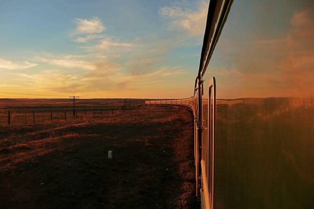 istock Transsiberian railway: long train making his way throught the desert in mongolia at sunset, as seen from the rear carriage 1164835757