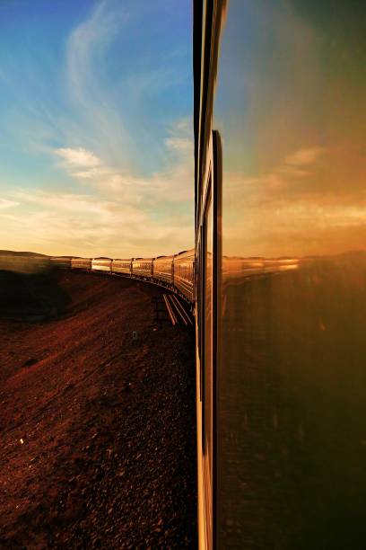istock Transsiberian railway: long train making his way throught the desert in mongolia at sunset, as seen from the rear carriage. Vertical. 1164835759