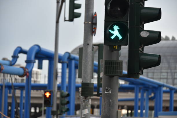 Green traffic light for pedestrians, Berlin Berlin, Germany - June 20, 2019: Green pedestrian traffic light with the Ampelmann of East Germany ampelmännchen photos stock pictures, royalty-free photos & images