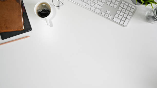 istock Office desk computer keyboard, coffee, pencil and book with copy space top view table. 1164836970