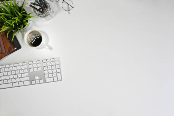 istock Office desk computer keyboard, coffee, pencil and book with copy space top view table. 1164836989