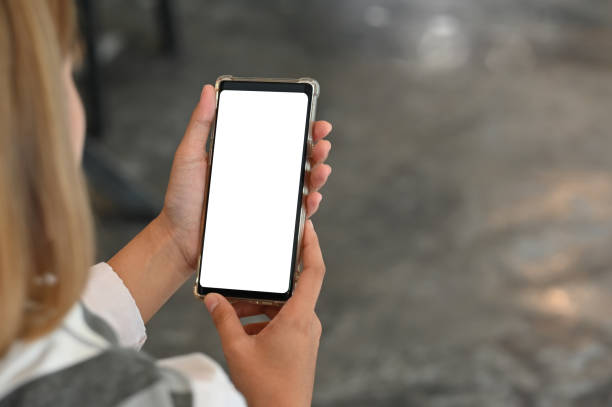 istock Young female using mobile phone with montage screen display. 1164837024