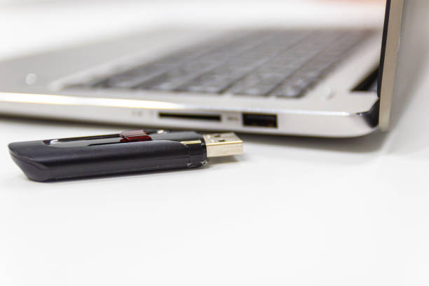 istock flash drive with laptop computer for conncet to USB port plug-in Laptop 1164838128