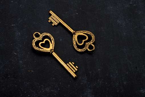 Unlock My Heart - Two Heart Shaped Golden Vintage Keys on Black Background