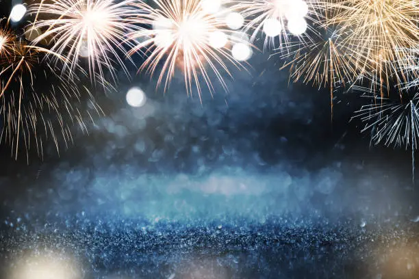 Photo of Gold and blue Fireworks and bokeh in New Year eve and copy space. Abstract background holiday.