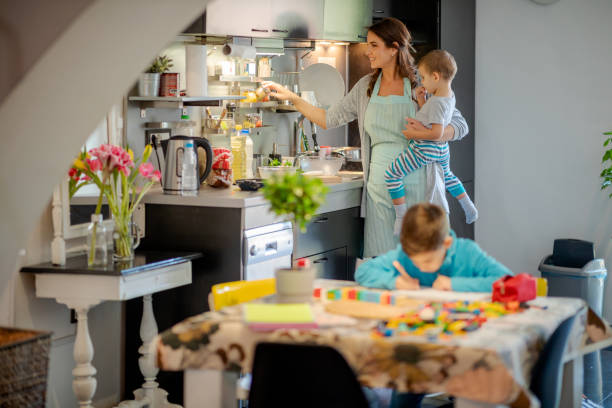 istock Happy mother choosing spice and cooking for sons 1164841694