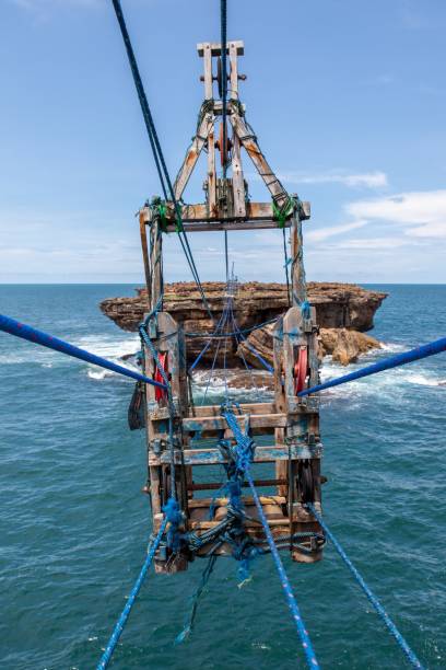 istock Cable car to small rocky island near Timang beach, Java, Indones. 1164842585