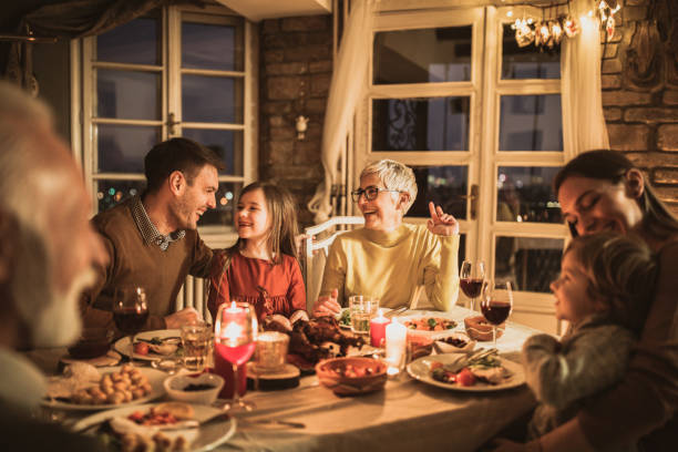 istock Happy multi-generation family talking during dinner at home. 1164843965